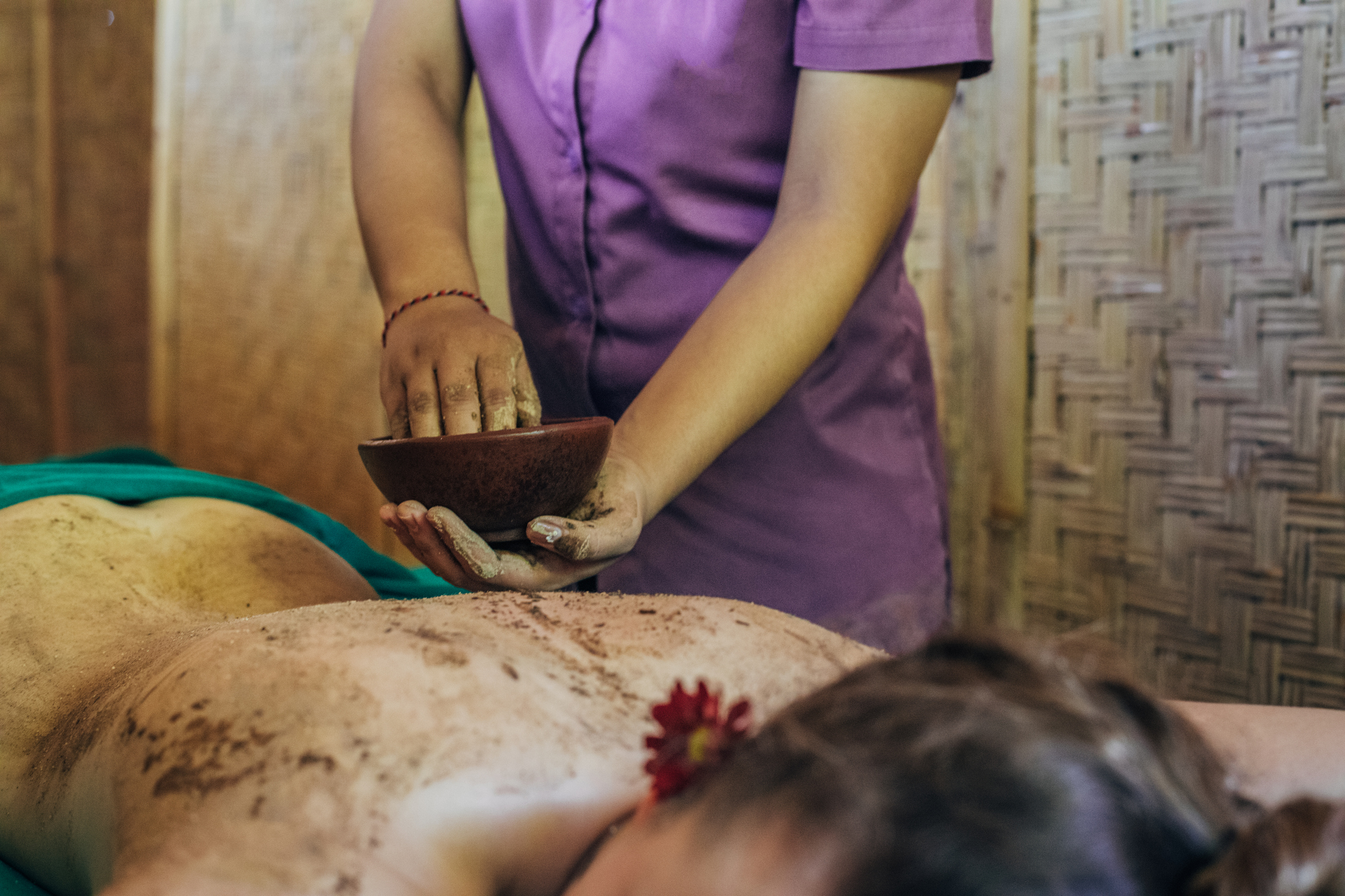 Woman getting treated with body mask